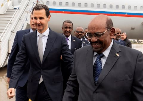 Syrian President Bashar Assad, left, meets with Sudan's President Omar al-Bashir in Damascus, Syria, - Credit: Sana