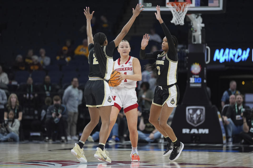 Nebraska guard Jaz Shelley, center, looks to pass as Purdue guards Rashunda Jones, left, and Jayla Smith, right, defend during the second half of an NCAA college basketball game at the Big Ten women's tournament Thursday, March 7, 2024, in Minneapolis. (AP Photo/Abbie Parr)
