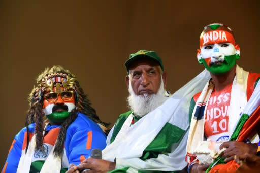 Pakistan cricket fan "Chacha Cricket", AKA Chacha Sufi Jalil (C) and Indian cricket fan Sudhir Gautam (R) attend a super-fan event in Manchester