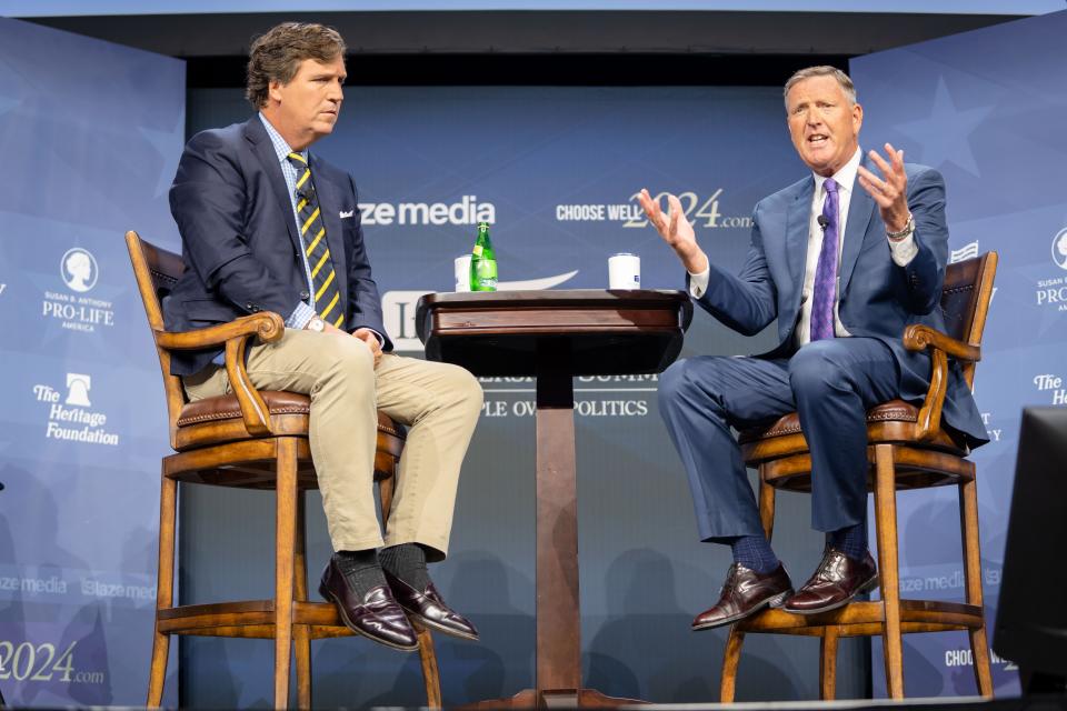 Tucker Carlson and Bob Vander Plaats speak during the Family Leadership Summit in Des Moines, Friday, July 14, 2023. 