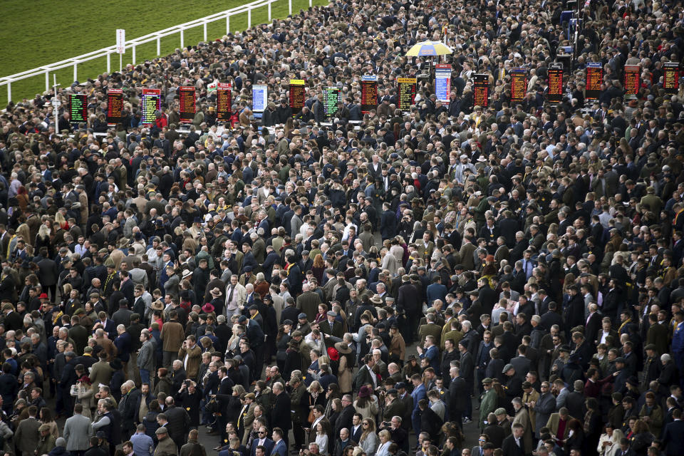 Crowds during day four of the Cheltenham Festival at Cheltenham Racecourse in Cheltenham, England, Friday, March 13, 2020. (Tim Goode/PA via AP)