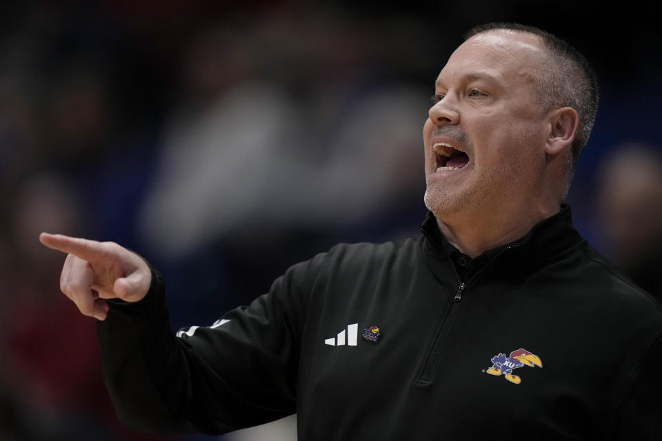 Kansas head coach Brandon Schneider talks to his players during the first half of an NCAA college basketball game against Baylor Wednesday, Jan. 10, 2024, in Lawrence, Kan. (AP Photo/Charlie Riedel)