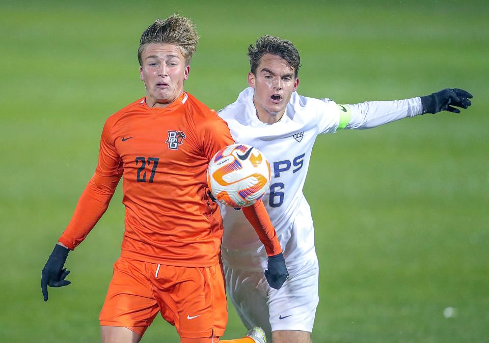 BGSU's Ashton Kamdem, left, and University of Akron's Sam Tojaga battle for control of a thrown in on Monday, Oct. 17, 2022 in Akron, Ohio, at FIrstEnergy Stadium.