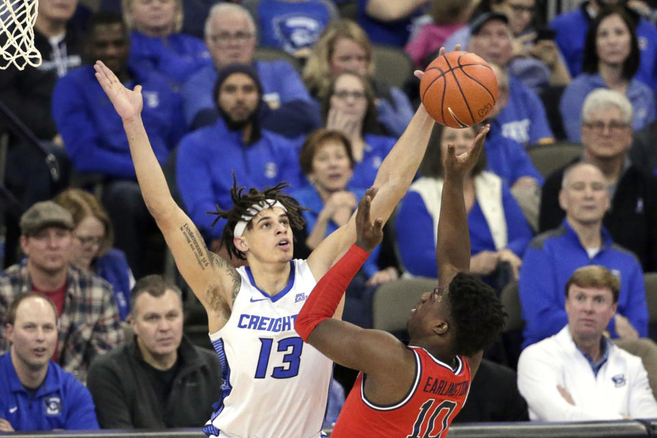 Creighton's Christian Bishop (13) blocks a shot by St. John's Marcellus Earlington (10) during the first half of an NCAA college basketball game in Omaha, Neb., Saturday, Feb. 8, 2020. (AP Photo/Nati Harnik)