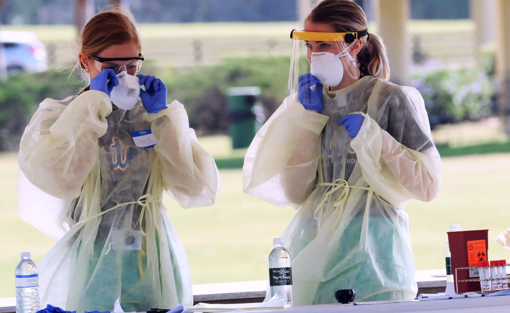 Healthcare workers wait for people to arrive at a COVID-19 mobile testing site in Florida. New reports from the UK show that both doctors and patients with exposure to the coronavirus are temporarily losing their sense of smell and taste. (Photo: Paul Hennessy/NurPhoto via Getty Images)