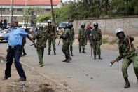 <p>Policemen attempt to disperse supporters of Kenyan opposition leader Raila Odinga of the National Super Alliance (NASA) coalition along Likoni road as they are repulsed from accessing city center, in Nairobi, Kenya, Nov. 17, 2017. (Photo: Thomas Mukoya/Reuters) </p>