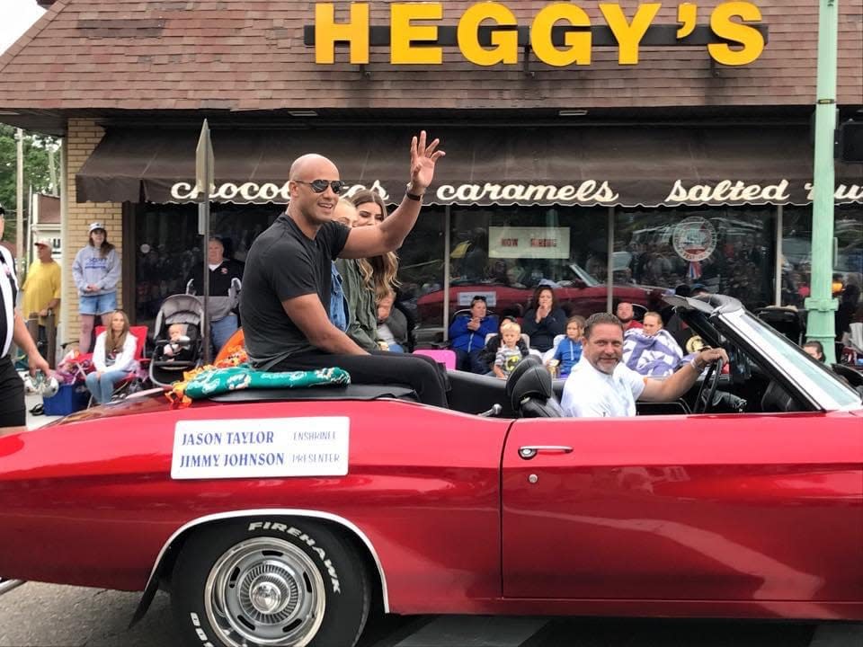 Jason Taylor, a 2017 Pro Football Hall of Fame inductee, rides in The Canton Repository Grand Parade, one of the signature events of the Pro Football Hall of Fame Enshrinement Festival.