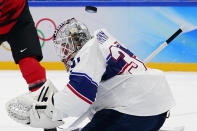 United States goalkeeper Strauss Mann (31) deflects a shot against Canada during a preliminary round men's hockey game at the 2022 Winter Olympics, Saturday, Feb. 12, 2022, in Beijing. (AP Photo/Matt Slocum)
