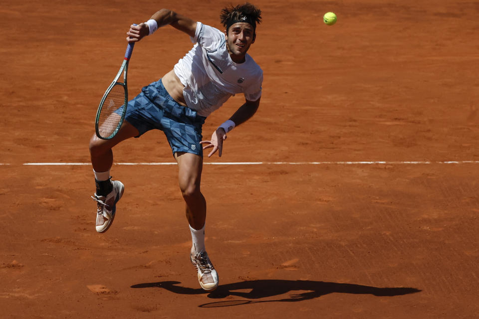 Tomas Martin Etcheverry of Argentina returns the ball against Casper Ruud of Norway during a semi final open tennis tournament in Barcelona, Spain, Saturday, April 20, 2024. (AP Photo/Joan Monfort)