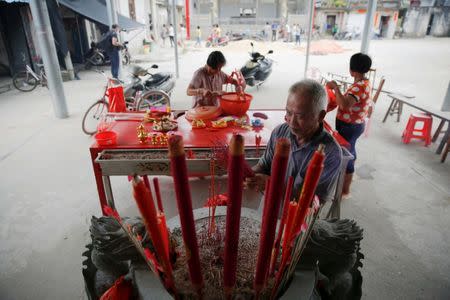 People gather at the temple after Tuesday's clashes between security forces and protesters in Wukan, Guangdong province, China, September 14, 2016. REUTERS/Damir Sagolj/File Photo