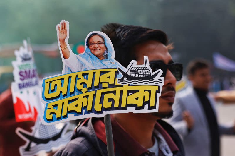 FILE PHOTO: A student holds a placard of Prime Minister Sheikh Hasina as they celebrate the formation day of Bangladesh Chhatra League, in Dhaka