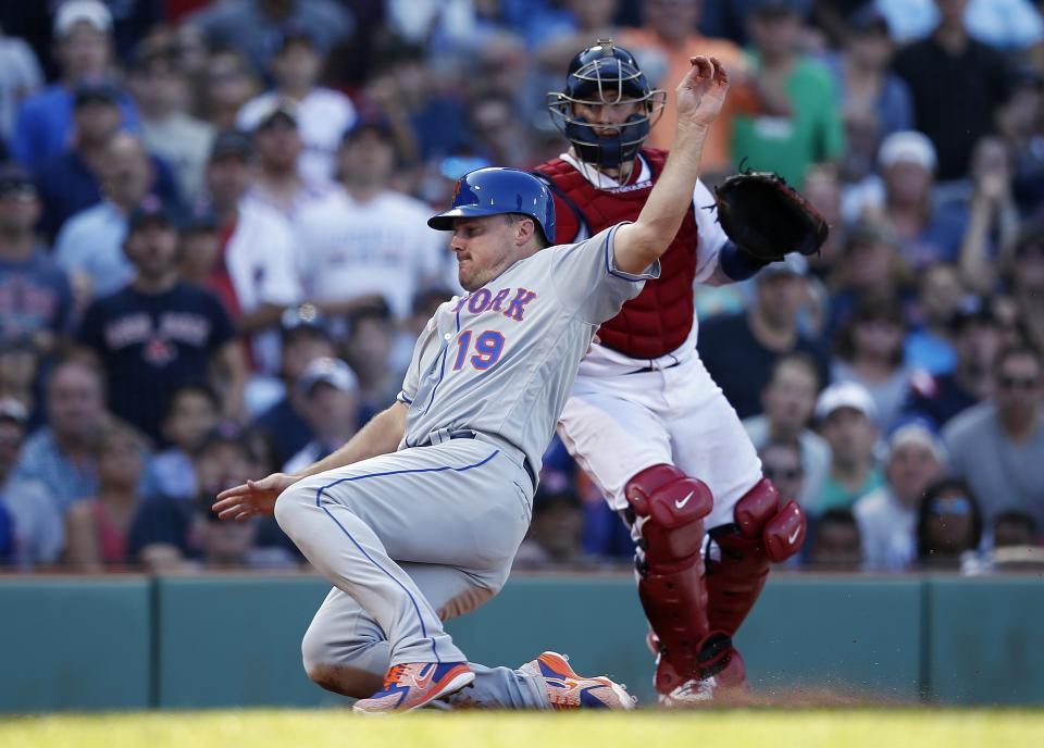 New York Mets' Jay Bruce (19) scores in front of Boston Red Sox's Christian Vazquez on a single by Amed Rosario during the seventh inning of a baseball game in Boston, Sunday, Sept. 16, 2018. (AP Photo/Michael Dwyer)