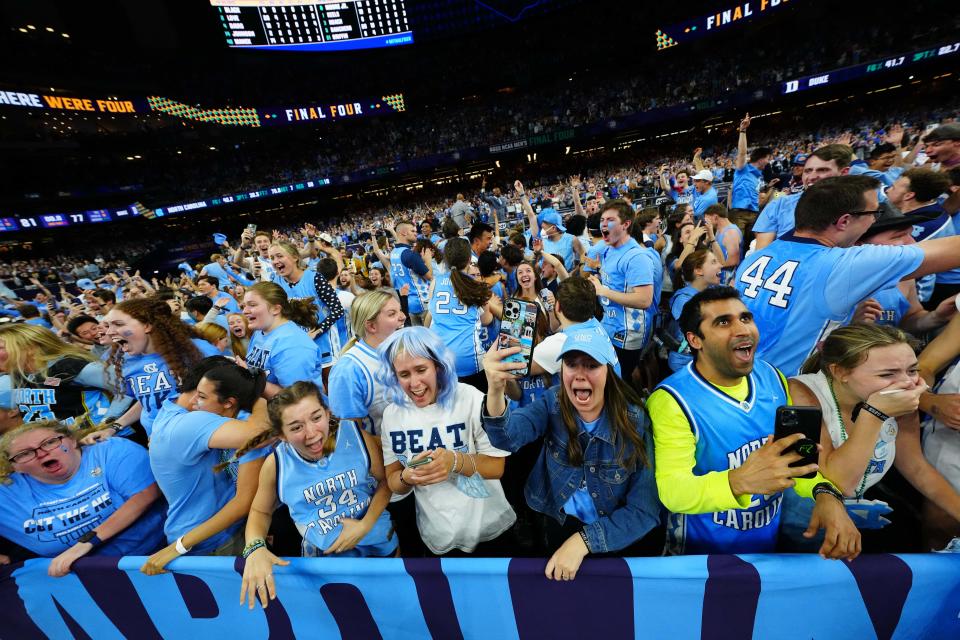 North Carolina Tar Heels fans celebrate after defeating the Duke Blue Devils during the 2022 NCAA men's basketball tournament Final Four semifinals at Caesars Superdome.