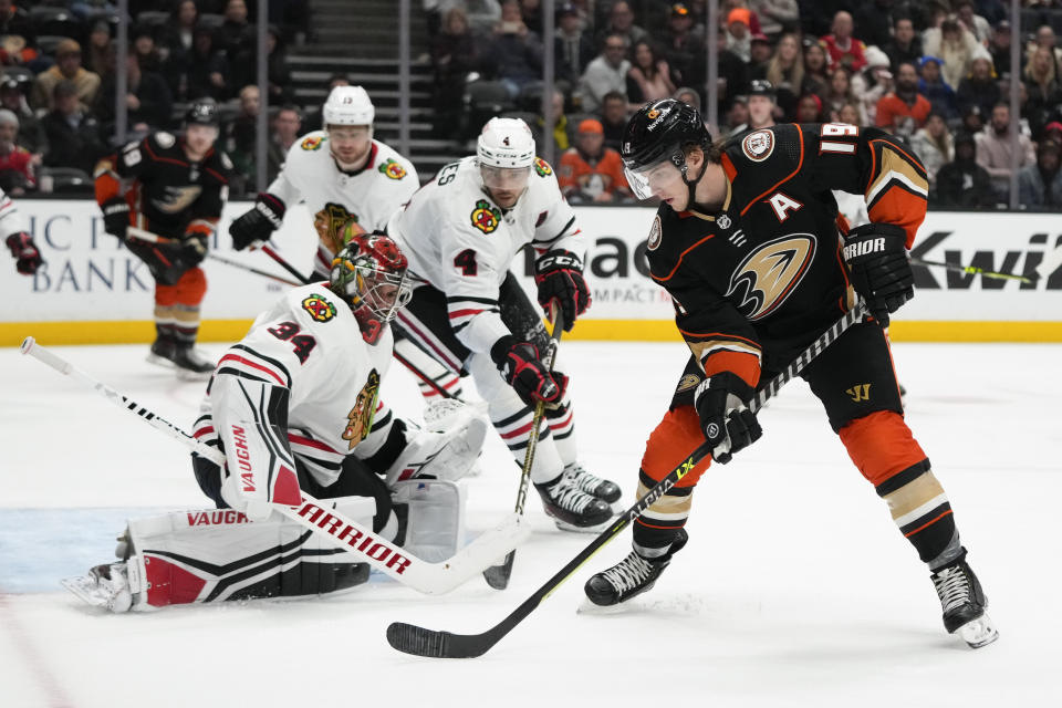 Anaheim Ducks' Troy Terry (19) sets up to shoot against Chicago Blackhawks goaltender Petr Mrazek (34) during the third period of an NHL hockey game Monday, Feb. 27, 2023, in Anaheim, Calif. The Ducks won 4-2. (AP Photo/Jae C. Hong)