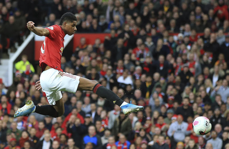 FILE - In this Sunday, Oct. 20, 2019 file photo Manchester United's Marcus Rashford scores his side's opening goal during the English Premier League soccer match between Manchester United and Liverpool at the Old Trafford stadium in Manchester, England. British Prime Minister Boris Johnson made an abrupt about-face Tuesday June 16, 2020 and agreed to keep funding meals for needy pupils over the summer holidays, after a campaign headed by young soccer star Marcus Rashford. The Manchester United and England player has been pressing the government not to stop a meal voucher program at the end of the school term in July. (AP Photo/Jon Super, File)