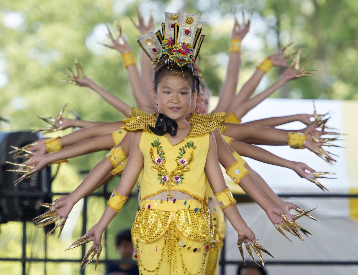 Savannah Williams was leading the beginning portion of the Thousand Hands Dance as members of the Lily Zhang Li Taylor Dance Academy performed for the crowd during the Ethnic Enrichment festival at Swope Park on Saturday, August 22, 2015.