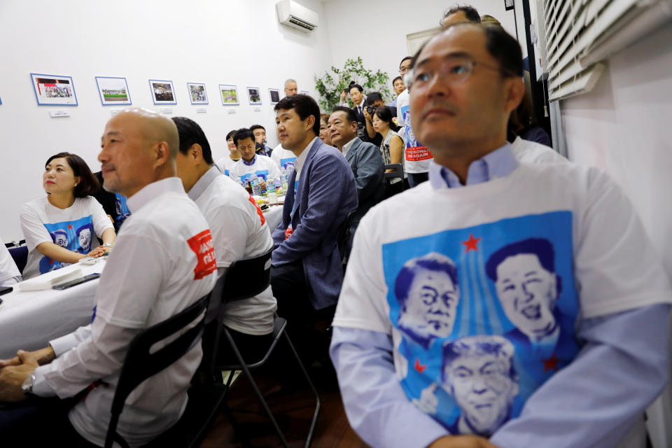 <p>At the Korean Association in Singapore, Koreans watch as President Trump meets North Korean leader Kim Jong Un on Tuesday. (Photo: Tyrone Siu/Reuters) </p>