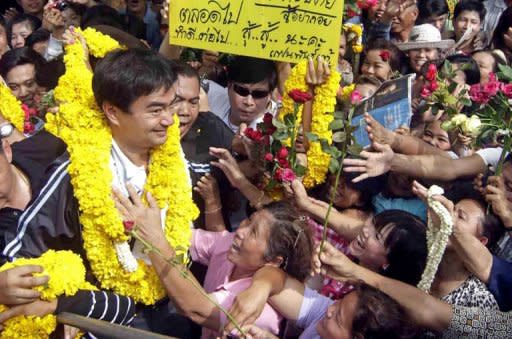 Thai Prime Minister Abhisit Vejjajiva (L) meets with supporters during an election campaign in Mahachai market, suburb of Bangkok on June 29, 2011. US officials are hoping Thailand's election will proceed smoothly and pave the way for reconciliation, but some fear for the worst -- particularly as the campaign has been dominated by divisive former premier Thaksin Shinawatra