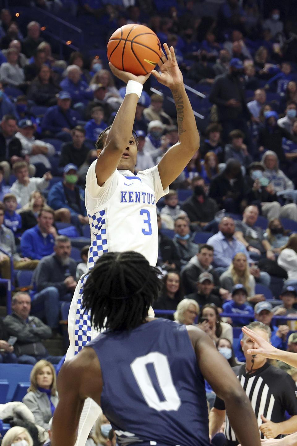 Kentucky's Tyty Washington Jr. (3) shoots while defended by North Florida's Emmanuel Adedoyin (0) during the first half of an NCAA college basketball game in Lexington, Ky., Friday, Nov. 26, 2021. (AP Photo/James Crisp)