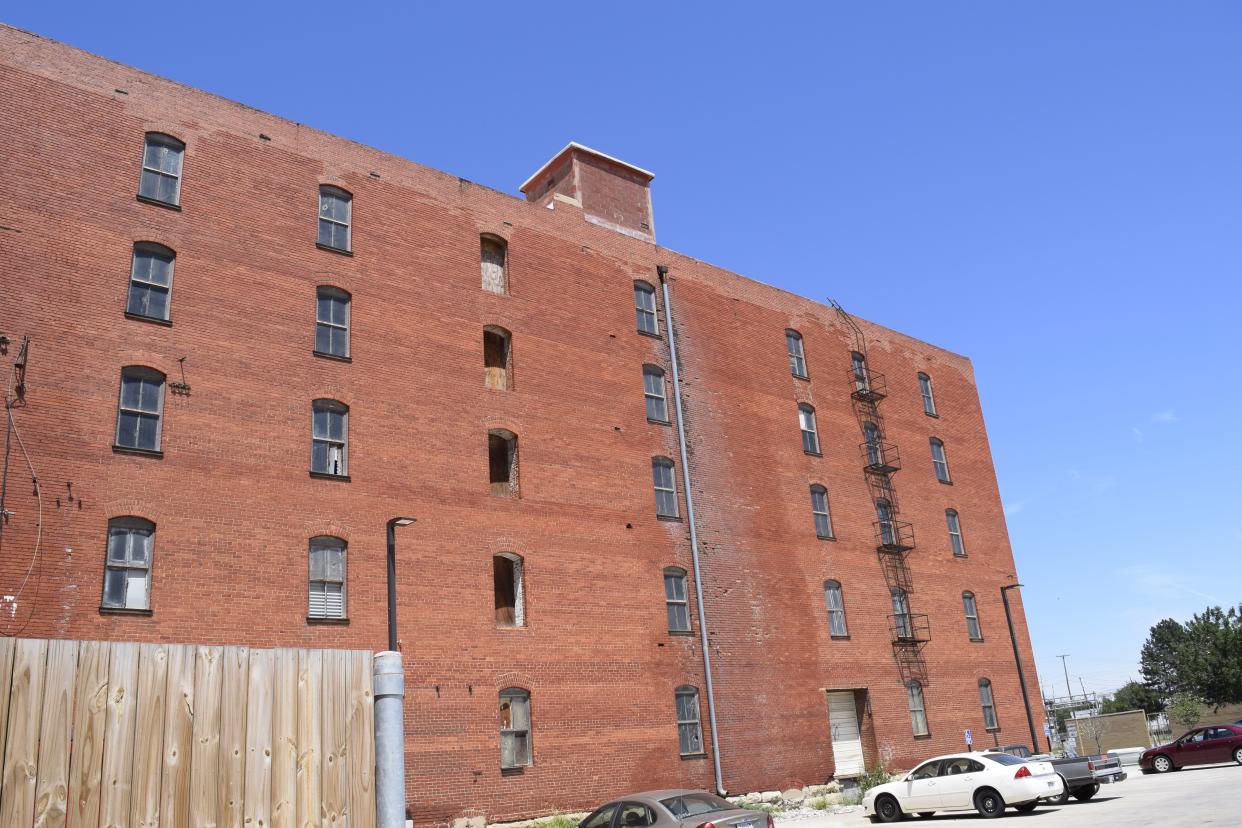 A view of the south wall of the Lee hardware building on Santa Fe Avenue near Elm Street. Overland Property Group is hoping to construction begin to the site in the beginning of 2023 to transform the building into space for 50 apartments and 8,000 square feet of commercial space.