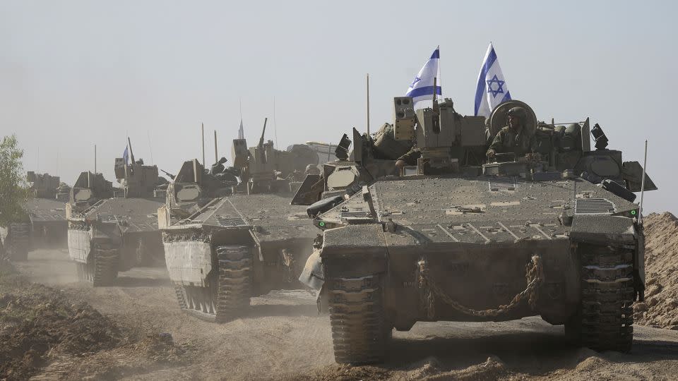 A convoy of Israeli army vehicles travels towards southern Israel, on November 24, marking the start of a four-day truce with Palestinian militant group Hamas. - Tsafrir Abayov/AP