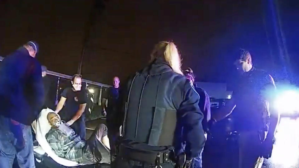 In this image from Altoona Police Department body-camera video, Demetrio Jackson is placed on a gurney after paramedics administered an injection of the sedative ketamine in a parking lot on the border of Altoona and Eau Claire, Wis., on Oct. 8, 2021. Later, Jackson stopped breathing on the way to Sacred Heart Hospital. He'd suffered cardiac arrest and had no brain function. (Altoona Police Department via AP)