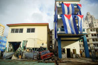 Damage is seen next to Cuban flags hung up to dry after Hurricane Irma caused flooding and a blackout, in Havana, Cuba September 11, 2017. REUTERS/Alexandre Meneghini