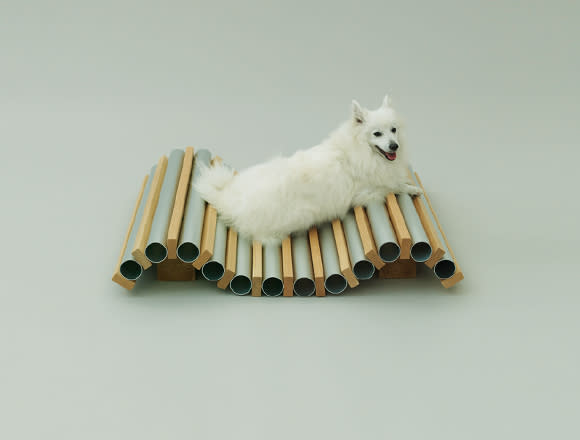 Architect Hiroshi Naito recalls his late dog, Pepe, a spitz who endured the extremely hot summers of Japan. In tribute to Pepe, he designed the Dog Cooler, made of aluminum tubes and wood planks. Ice can be inserted into the tubes to cool the dog, he says. It can be adapted to the layout of your room. (Photo by Hiroshi Yoda / <a href="http://www.architecturefordogs.com/" rel="nofollow noopener" target="_blank" data-ylk="slk:Architecture for Dogs;elm:context_link;itc:0;sec:content-canvas" class="link ">Architecture for Dogs</a>)
