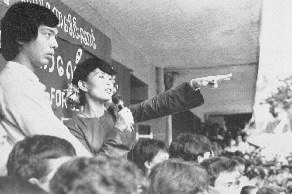 FILE - Burma's main opposition leader Aung San Suu Kyi, second left, addresses thousands at a rally in Rangoon, Burma on Oct. 14, 1991. Myanmar court on Monday, Dec. 6, 2021, sentenced ousted leader Suu Kyi to 4 years for incitement and breaking virus restrictions, then later in the day state TV announced that the country's military leader reduced the sentence by two years. (The Nation via AP, File)