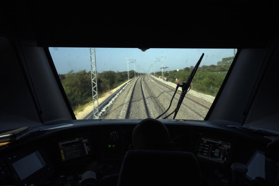 Railroad tracks extend in front of the windshield of a Maya Train traveling from Cancun to Valladolid, Mexico, Wednesday, March 6, 2024. When it's completed, the high-speed Maya Train will wind around Mexico's southern Yucatan peninsula. (AP Photo/Rodrigo Abd)