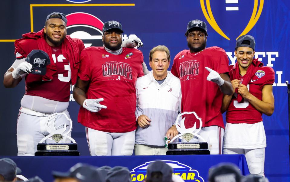 Nick Saban is out of work and could be perfect for the job as College Football Commissioner. Here he poses with players on Dec. 12.