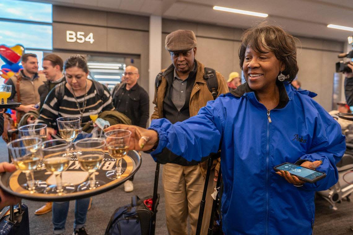 Amania Drane, a passenger on Southwest Airlines from Chicago, is greeted with champagne and mimosas at Kansas City International Airport on Tuesday, Feb. 28, 2023. Southwest Airlines was one of the first airlines to arrive to Kansas City International Airport’s new terminal.