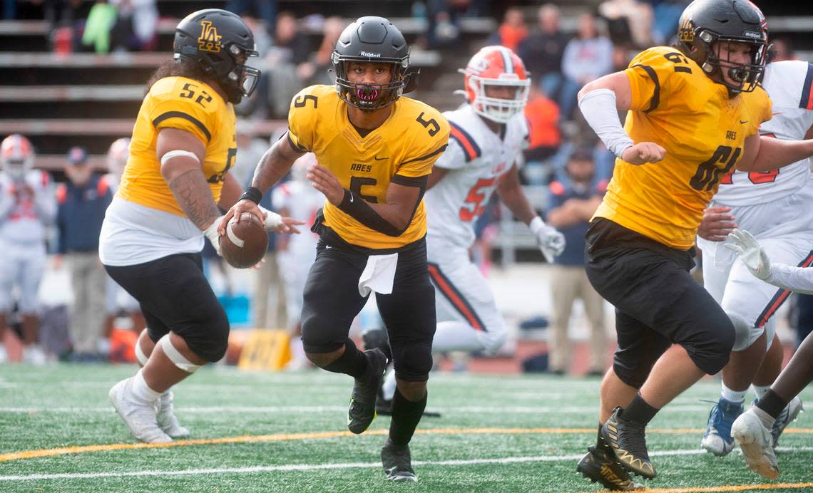 Lincoln quarterback Gabarri Johnson scrambles for a touchdown run during Saturday afternoon’s football game against the Lakes Lancers at Lincoln Bowl in Tacoma, Washington, on Oct. 22, 2022.