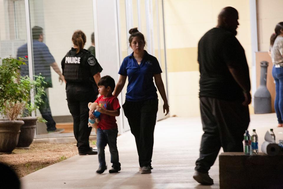 A woman and child leave the Civic Center after a mass shooting at Robb Elementary School in Uvalde, Texas (Reuters)