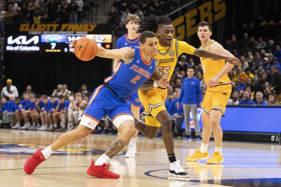 Florida's Riley Kugel, left, drives past Missouri's Sean East II during the first half of an NCAA college basketball game Saturday, Jan. 20, 2024, in Columbia, Mo. (AP Photo/L.G. Patterson)