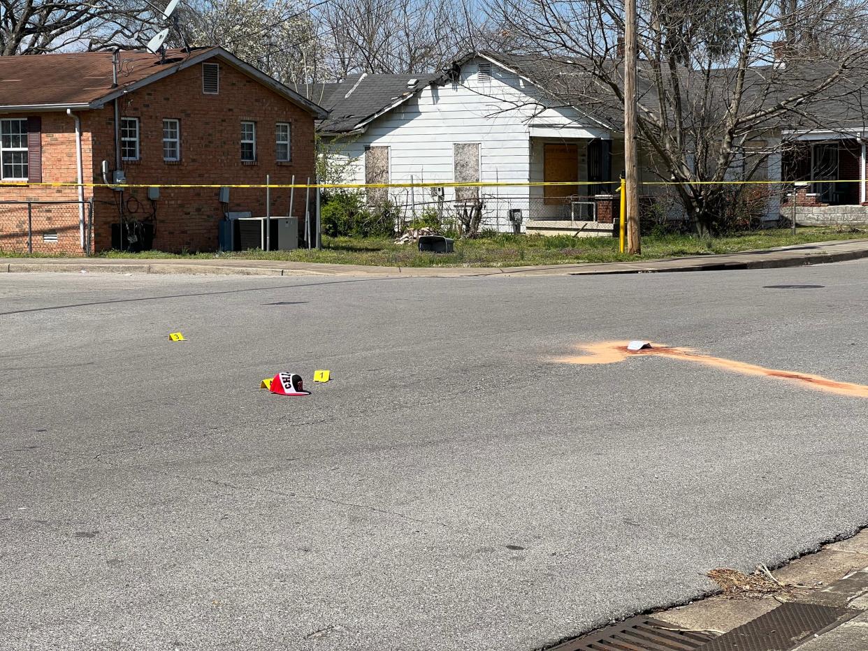 Evidence markers are seen on the street after police said a man was fatally shot while walking near 22nd Avenue North and Underwood Street in Nashville on Monday morning.