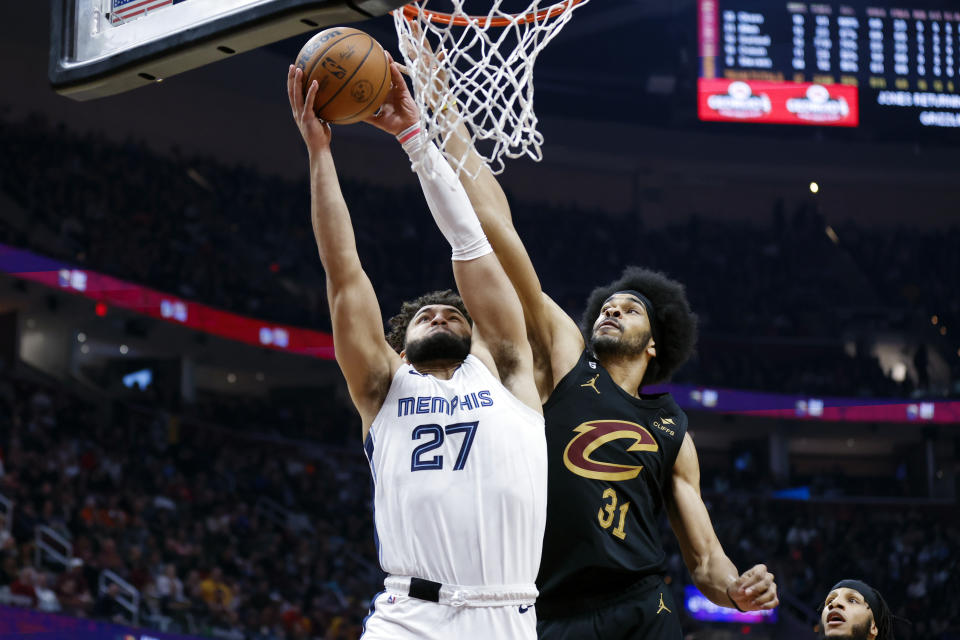 Memphis Grizzlies forward David Roddy (27) shoots ahead of Cleveland Cavaliers center Jarrett Allen (31) during the first half of an NBA basketball game, Thursday, Feb. 2, 2023, in Cleveland. (AP Photo/Ron Schwane)