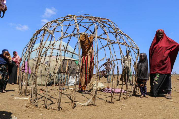 Batulo Mohamed, a drought-displaced mother of five, constructs a temporary shelter on the outskirts of Baidoa in southern Somalia