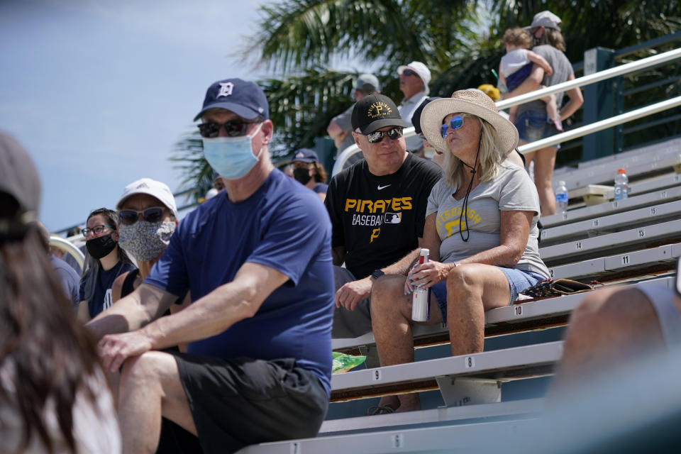 A limited number of socially distanced fans watch a spring training exhibition baseball game between the Pittsburgh Pirates and the Detroit Tigers at LECOM Park in Bradenton, Fla., Friday, March 26, 2021. Spring has arrived, and many older adults who have been vaccinated are emerging from hibernation imposed by the coronavirus pandemic. (AP Photo/Gene J. Puskar)