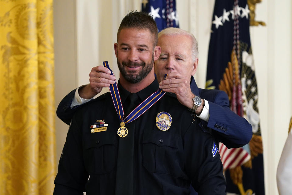 CORRECTS FROM LITTLETOWN TO LITTLETON - President Joe Biden presents the Medal of Valor, the nation's highest honor for bravery by a public safety officer, to Cpl. Jeffrey Farmer, of the Littleton, Colo., Police Dept., during an event in the East Room of the White House, Wednesday, May 17, 2023, in Washington. (AP Photo/Evan Vucci)