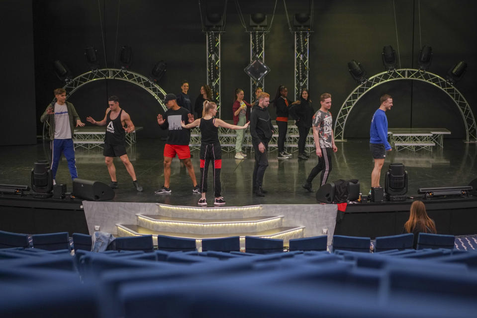 Dancers and actors practice in the theater of the MSC Grandiosa cruise ship in Civitavecchia, near Rome, Wednesday, March 31, 2021. MSC Grandiosa, the world's only cruise ship to be operating at the moment, left from Genoa on March 30 and stopped in Civitavecchia near Rome to pick up more passengers and then sail toward Naples, Cagliari, and Malta to be back in Genoa on April 6. For most of the winter, the MSC Grandiosa has been a lonely flag-bearer of the global cruise industry stalled by the pandemic, plying the Mediterranean Sea with seven-night cruises along Italy’s western coast, its major islands and a stop in Malta. (AP Photo/Andrew Medichini)