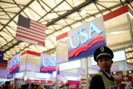 A security officer keeps watch at U.S. food booths at SIAL food innovation exhibition, in Shanghai