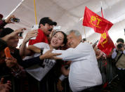 Leftist front-runner Andres Manuel Lopez Obrador of the National Regeneration Movement (MORENA) poses for a selfie with a supporter during his campaign rally in Cuautitlan Izcalli, Mexico, April 13, 2018. REUTERS/Henry Romero