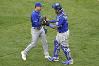 Kansas City Royals relief pitcher Kyle Zimmer, left, celebrates with catcher Salvador Perez after the Kansas City Royals defeated the Chicago White Sox in a baseball game in Chicago, Sunday, April 11, 2021. (AP Photo/Nam Y. Huh)