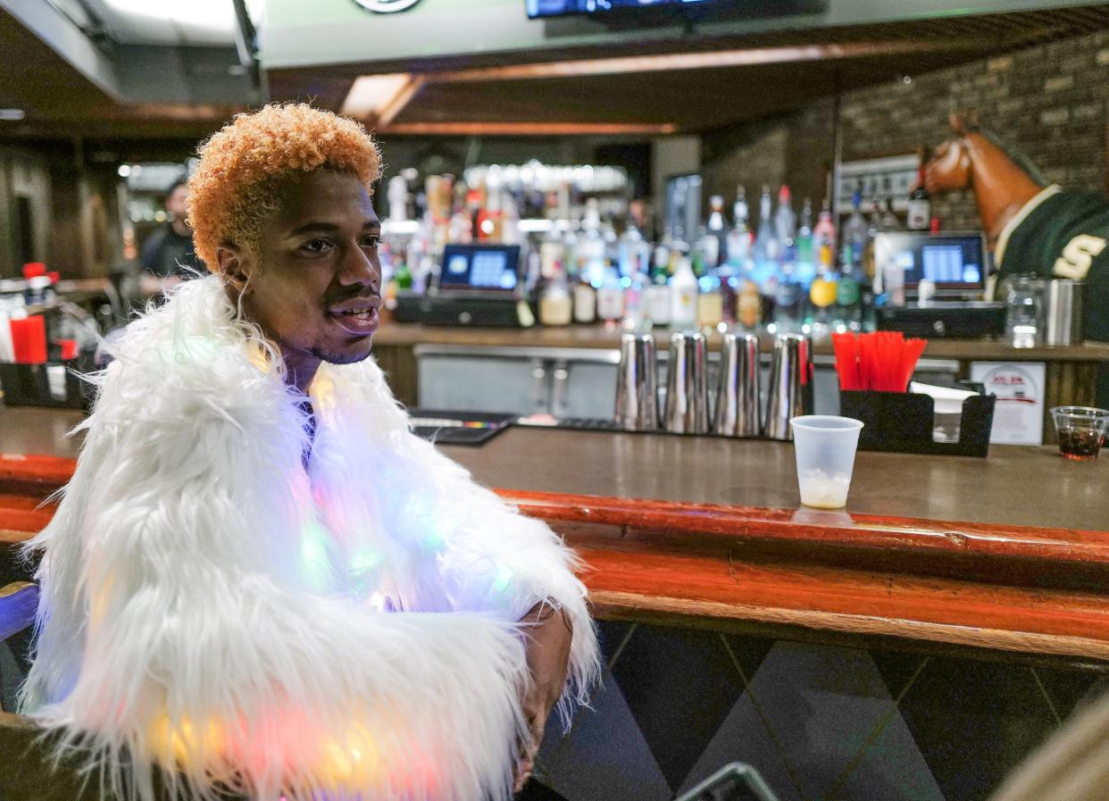 Armon Caston from Lansing, who goes by the stage name of Aurora Manifesto, sometimes visits The Junction bar in Lansing Township in drag or like here, in something fancy on Sunday, Jan 29, 2023.