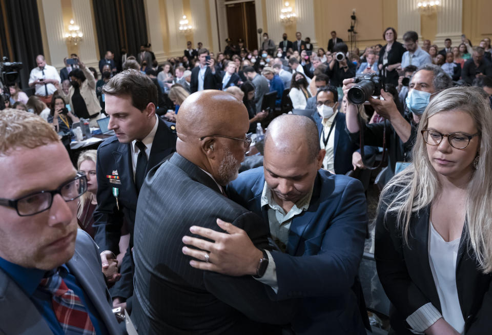 Chairman Bennie Thompson, D-Miss., center left, embraces U.S. Capitol Police Sgt. Aquilino Gonell, as the House select committee investigating the Jan. 6 attack on the U.S. Capitol finished a hearing on extremist groups, at the Capitol in Washington, Tuesday, July 12, 2022. At left is Stephen Ayres, who pleaded guilty in June 2022 to disorderly and disruptive conduct in a restricted building, and who was a witness at the hearing. (AP Photo/J. Scott Applewhite)