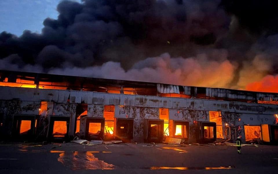 A frozen food warehouse is seen on fire after shelling, as Russia's attack on Ukraine continues, in the village of Kvitneve in Kyiv region, Ukraine, on March 12, 2022. - SES via Reuters/SES via Reuters