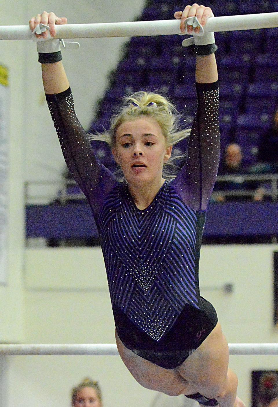 Watertown's Kinsley Van Gilder hangs from the uneven bars during the Watertown Invitational gymnastics meet on Saturday, Jan. 21, 2023 in the Civic Arena.