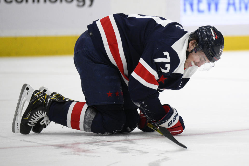 Washington Capitals right wing T.J. Oshie (77) grimaces during the second period of an NHL hockey game against the New York Islanders, Tuesday, April 26, 2022, in Washington. (AP Photo/Nick Wass)