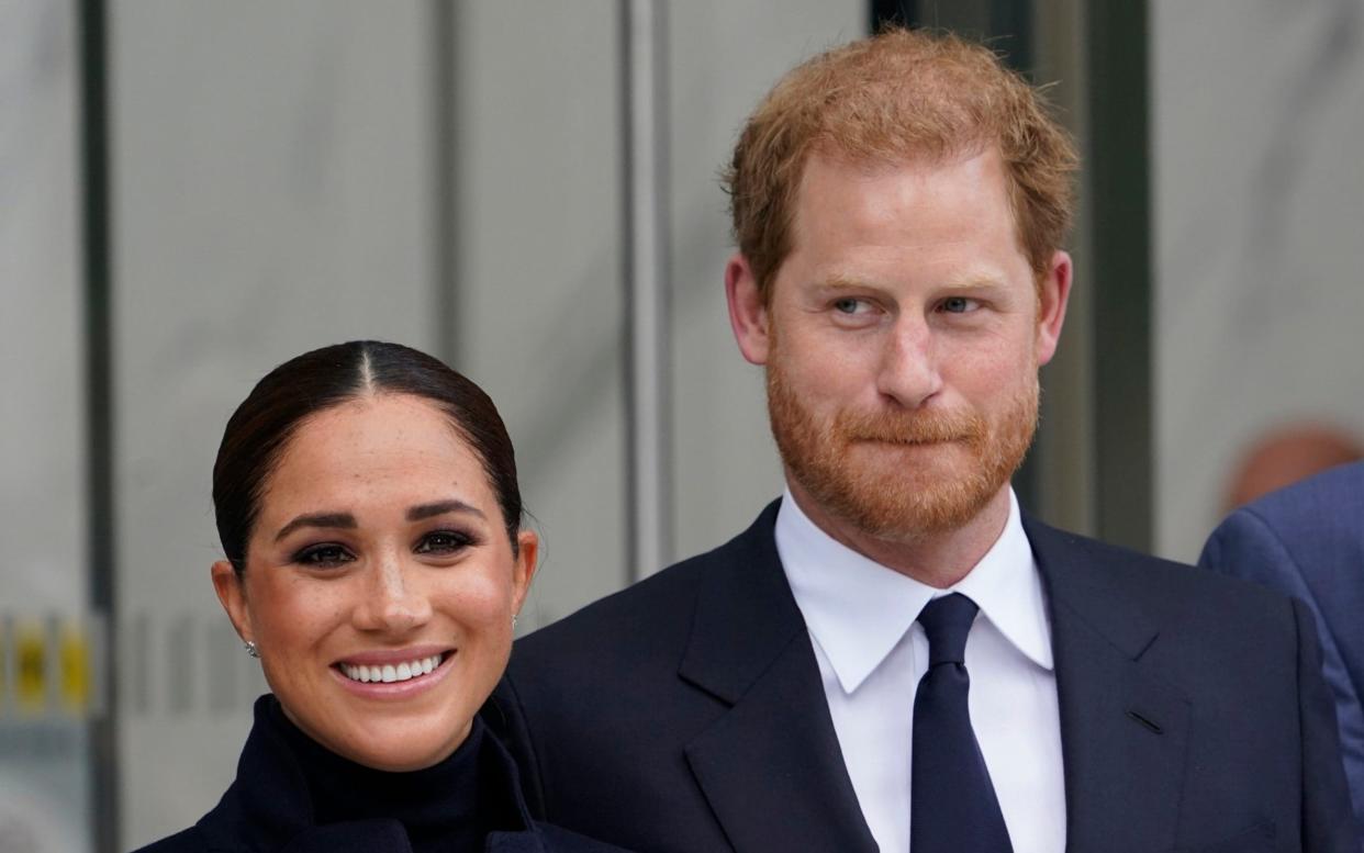 FILE - Meghan Markle and Prince Harry pose for pictures after visiting the observatory in One World Trade in New York, Sept. 23, 2021. The Duchess of Sussex will receive a nominal Â£1 payment for invasion of privacy plus undisclosed damages for copyright infringement under an agreement that ends her long-running dispute with Britain's Mail on Sunday over the tabloid's publication of a letter she wrote to her father. The terms were reported on Wednesday, Jan. 5, 2022, 10 days after Associated Newspapers Ltd., publisher of the Mail on Sunday, decided to forego further appeals and published a statement acknowledging that the U.S.-born duchess, formerly known as Meghan Markle, had won her lawsuit.(AP Photo/Seth Wenig, File) - AP
